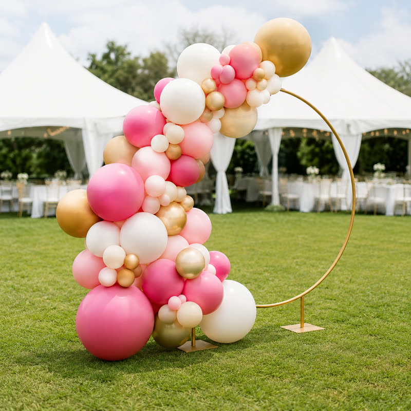 Pink, white and gold balloon garland styled on a round gold hoop
