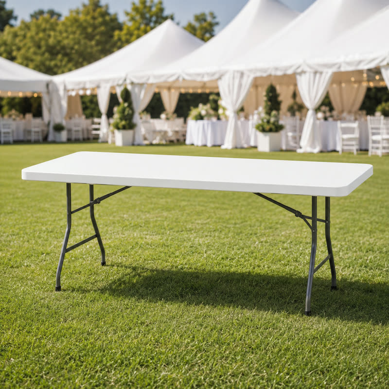 White 6-foot folding table set up on a lawn