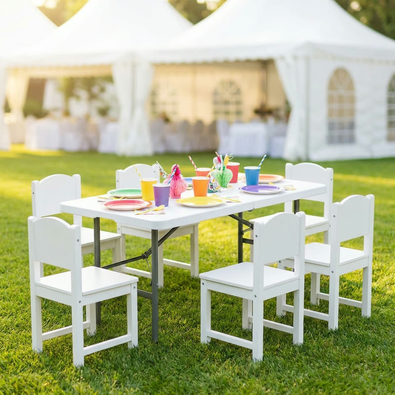 Kid-sized folding table with small white chairs ready for a party