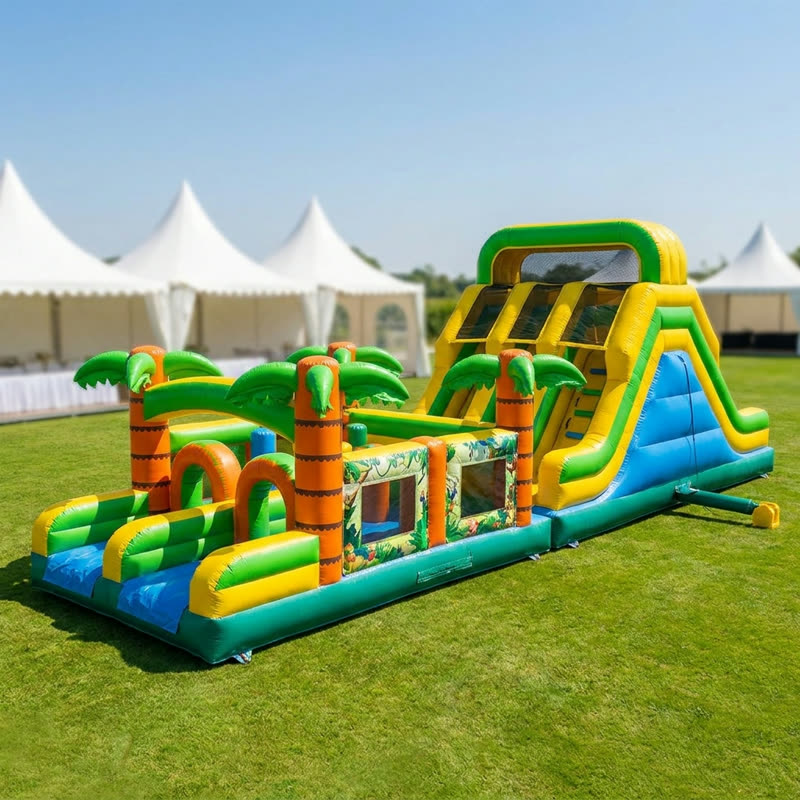 Tropical double-lane inflatable obstacle course with palm trees, climb wall and slide finish